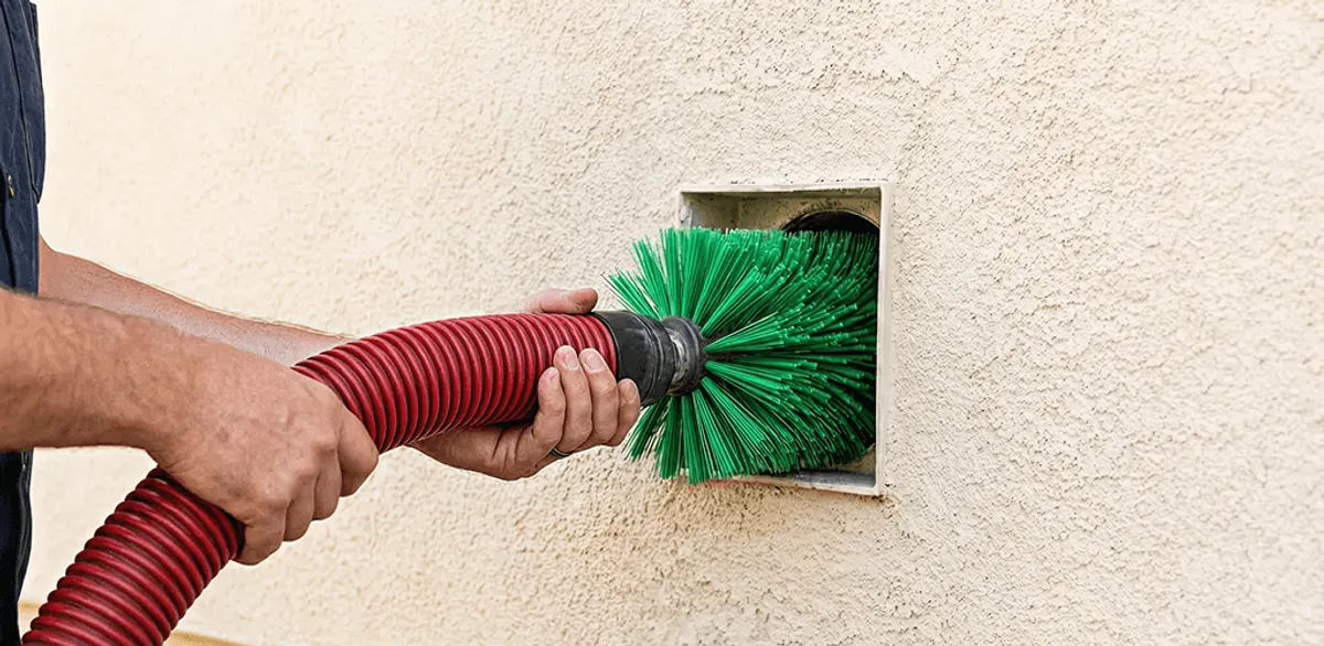 Air duct cleaning brush removing debris from a vent opening in Tempe, AZ