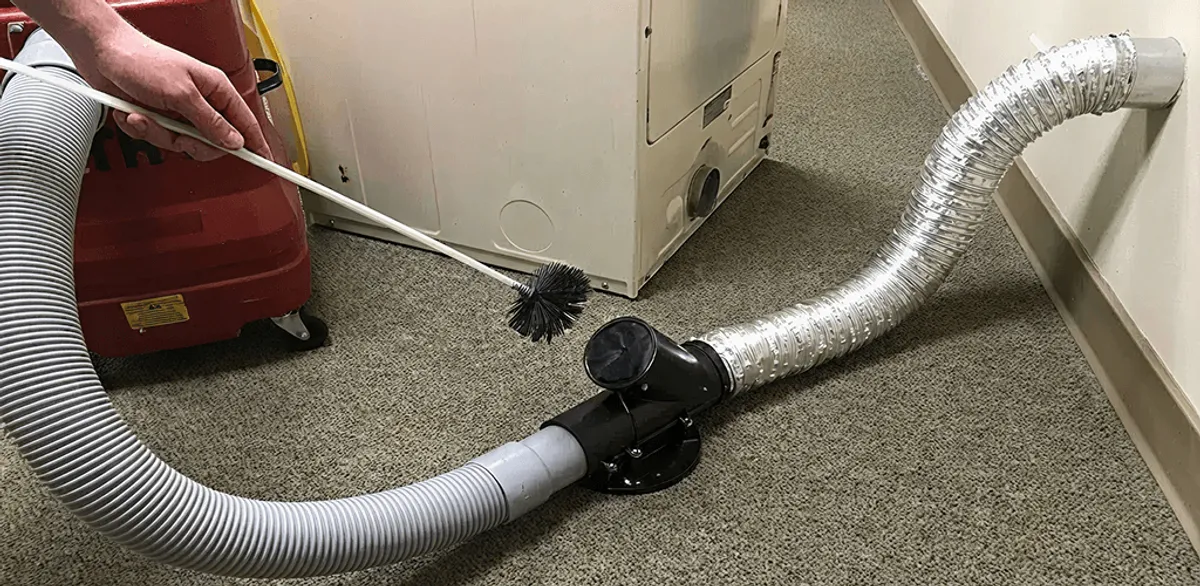 Dryer vent cleaning service removing lint from a dryer duct connection in Tempe, AZ