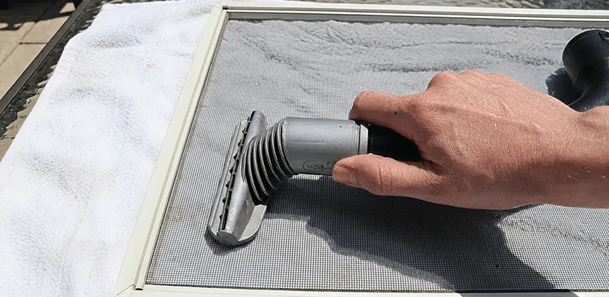 Window screen repair cleaning and fixing a damaged screen mesh in Tempe, AZ